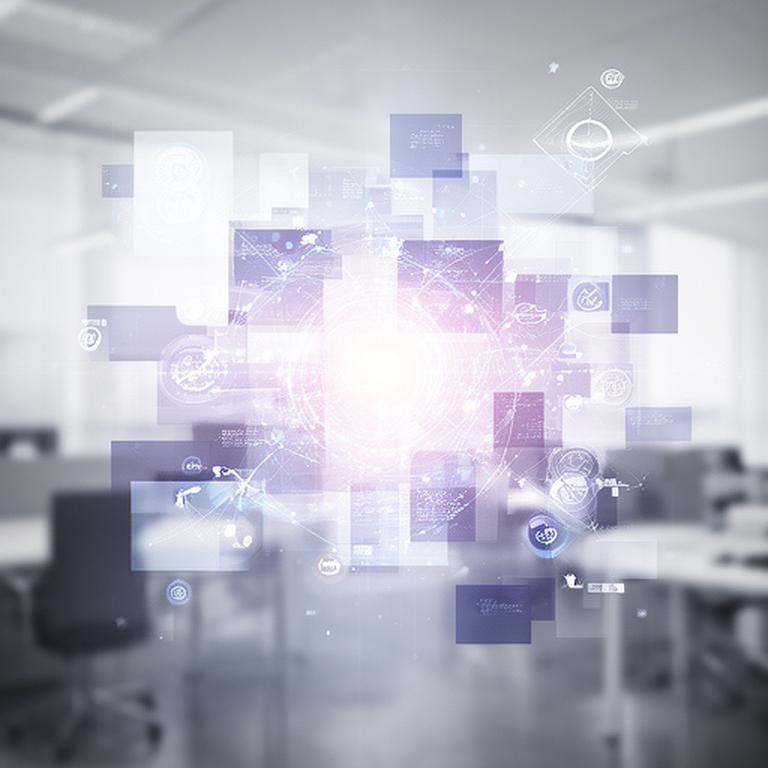 A modern desk with industry icons arranged around a glowing database interface in a Flint office