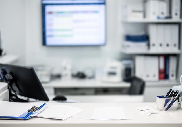 Clinic front desk with a digital scheduling screen and organised appointment workflow