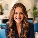 Salon owner smiling in a stylish reception area